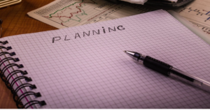 Ringed book with the word "PLANNING" written at the top of a page.